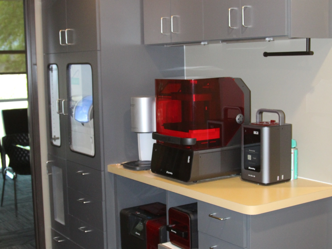 Sprintray Pro 2 Dental 3D Printer and Midas Unit on a Countertop Beside a CBCT Scanner