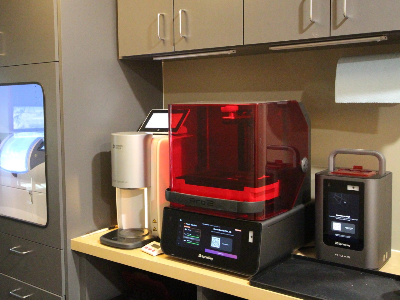 Sprintray Pro 2 Dental 3D Printer and Midas Unit on a Countertop Beside a CBCT Scanner